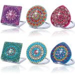 Conjunto de anillos Punto De Diamante con diseños circulares y brillo de piedras en colores vibrantes.